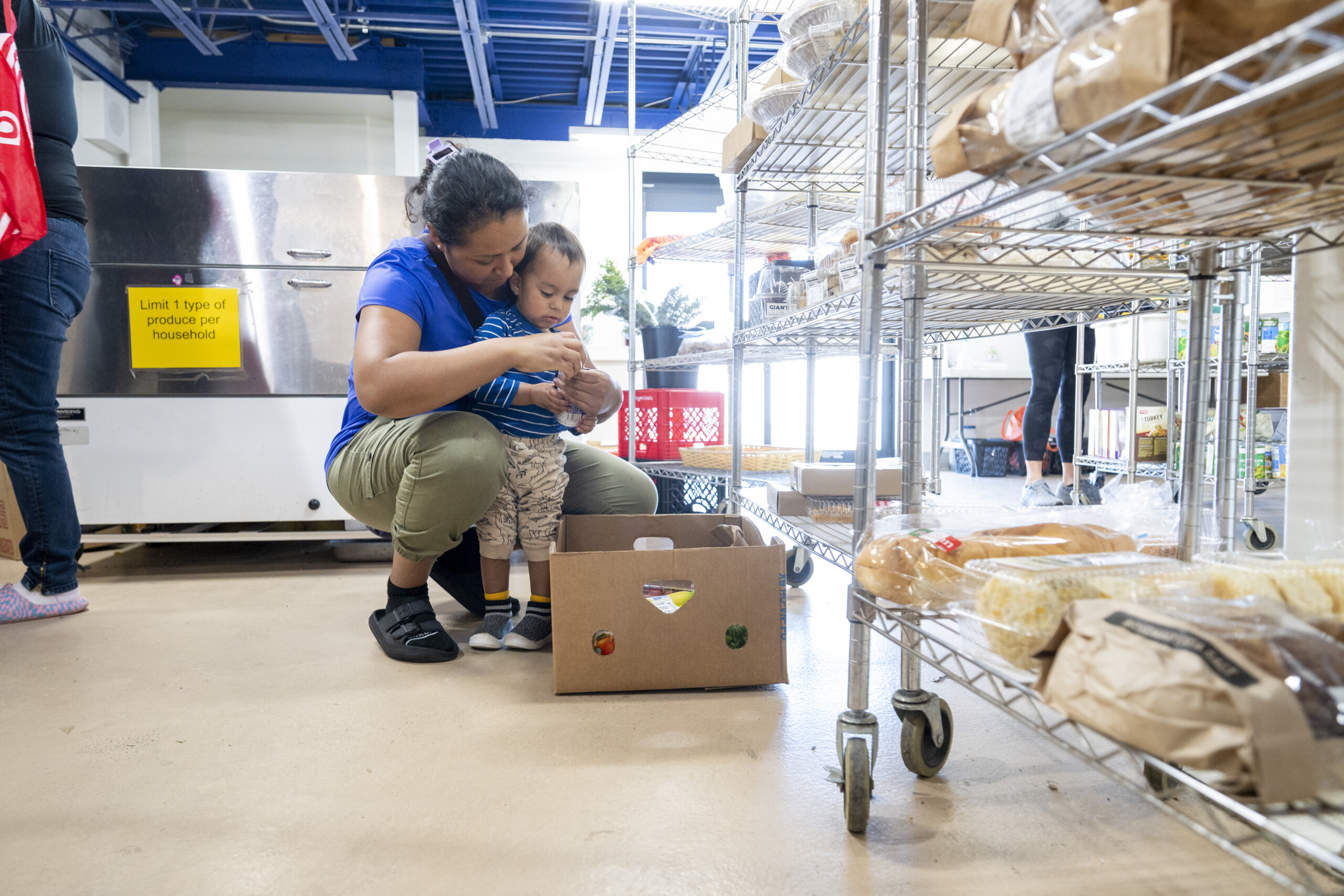 central-pa-food-bank-food-assistance-programs A parent and young child selecting food at a Central Pennsylvania Food Bank partner pantry.